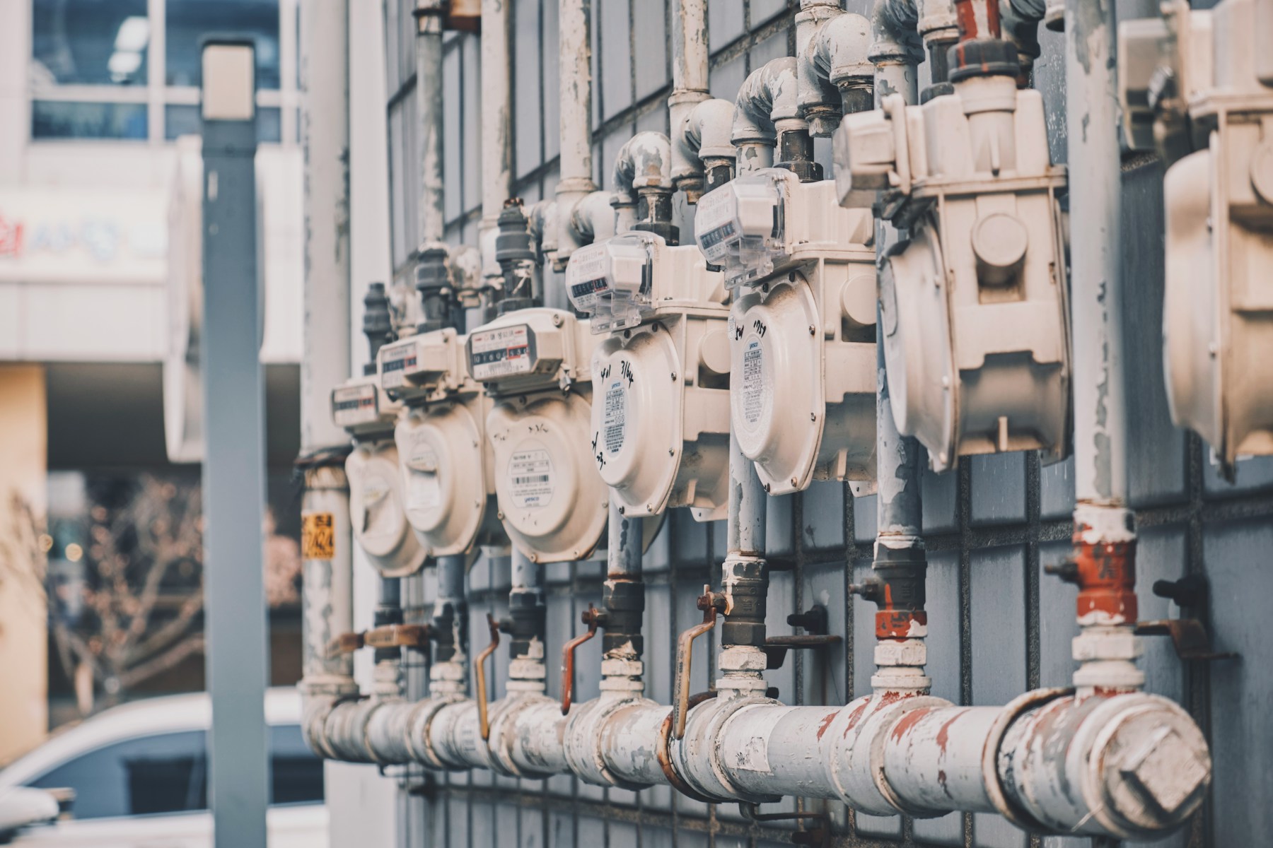 Pipes attached to a building showing water supply infrastructure